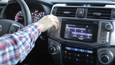 Distracted driver adjusting car radio