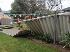 Wind-damaged fence