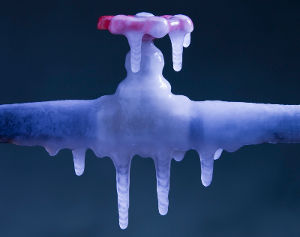 Frozen outdoor faucet in winter