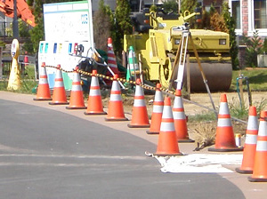 Landscaping contractors at work using safety cones