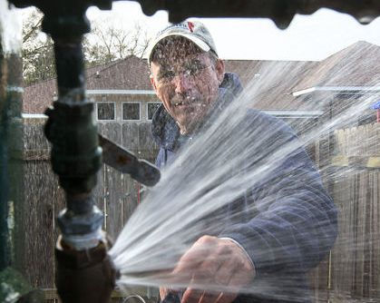 Frozen pipe spraying water in winter
