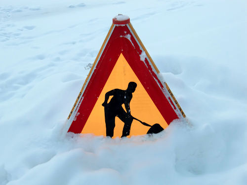 Winter risks sign in snow